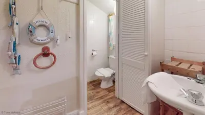 a white bathroom with a sink and a toilet at A18 Bojago, Riviere Towans in Hayle