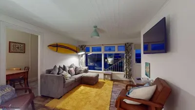 a living room with a couch and a window at A18 Bojago, Riviere Towans in Hayle