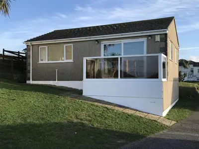 a house with a large window on the side of it at A19 Eatondale, Riviere Towans in Hayle