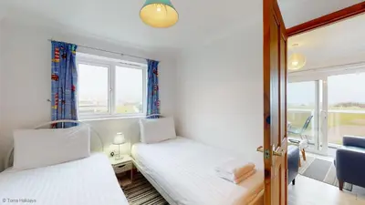 a small room with two beds and a window at A19 Eatondale, Riviere Towans in Hayle