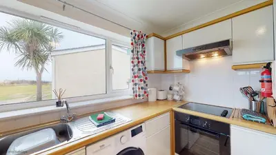 a kitchen with a sink and a window at A19 Eatondale, Riviere Towans in Hayle