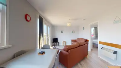 a living room with a couch and a table at A21 Solano, Riviere Towans in Hayle