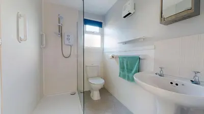 a bathroom with a sink and a toilet and a shower at A21 Solano, Riviere Towans in Hayle