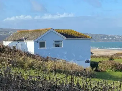 a small white house on top of a hill at B11 Treague, Riviere Towans in Hayle