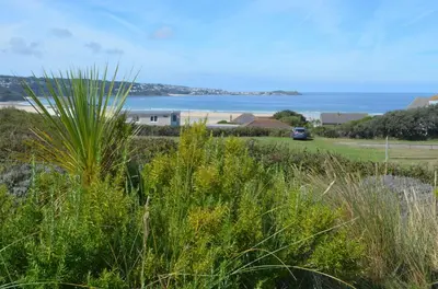 a view of the ocean from a field of grass at B11 Treague, Riviere Towans in Hayle