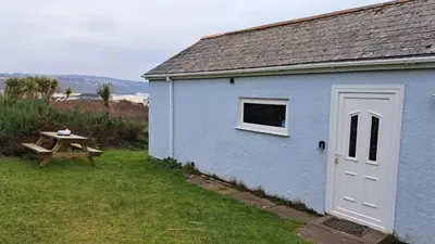 a blue building with a picnic table next to it at B11 Treague, Riviere Towans in Hayle