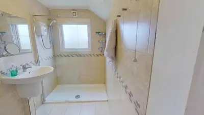 a white bathroom with a sink and a shower at B11 Treague, Riviere Towans in Hayle