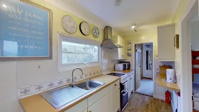 a kitchen with a sink and a window at B11 Treague, Riviere Towans in Hayle