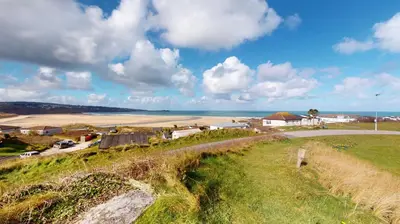 a view of the beach from a hill with a road at B38 Delamar, Riviere Towans in Hayle
