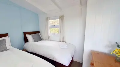 a small room with two beds and a window at B14 Amulree, Riviere Towans in Hayle