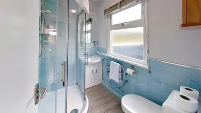 a bathroom with a shower and a toilet and a sink at A06 Rushdune A6, Riviere Towans in Hayle