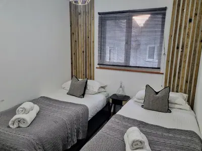 a bedroom with two beds with towels on them at Bungalow 62,North Cornwall, St. Tudy in Saint Tudy