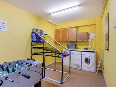 a laundry room with a washer and a washing machine at Seascape in Porthleven
