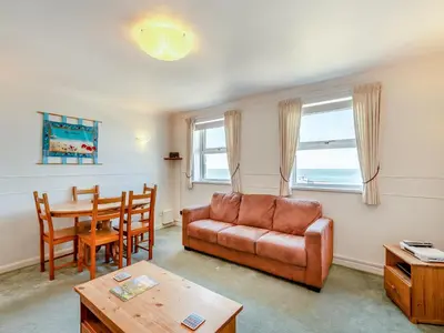 a living room with a couch and a table at Seascape in Porthleven