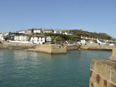 a view of a river with buildings in the background at Seascape in Porthleven