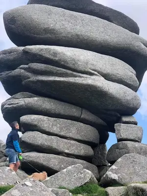 a man standing in front of a stack of rocks at Bracken's Retreat in Lostwithiel