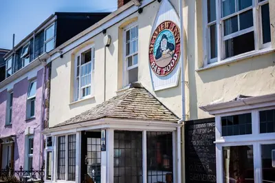 a building with a clock on the side of it at Stylish Central Famouth Studio with Parking | WiFi | in Falmouth