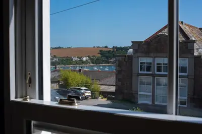 a window with a view of a building at Central Falmouth Flat with Free Parking in Falmouth