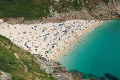 a large group of people on a beach at Central Falmouth Flat with Free Parking in Falmouth