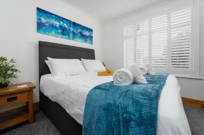 a bedroom with a large bed with towels on it at Trevelyan in St Ives
