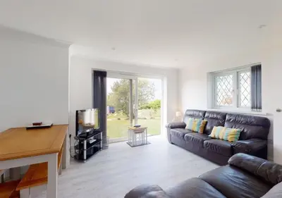 a living room with a couch and a tv at B51 Blue Bay, Riviere Towans in Hayle
