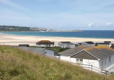 a view of a beach with houses and the ocean at B51 Blue Bay, Riviere Towans in Hayle