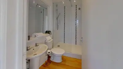 a white bathroom with a sink and a toilet at B50 Kingfisher, Riviere Towans in Hayle