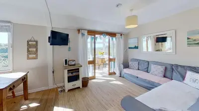 a living room with a couch and a table at C15 Seamore, Riviere Towans in Hayle