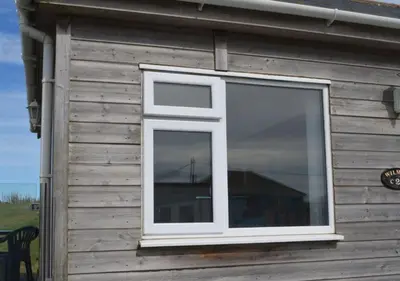 a window on the side of a house with a bridge at C23 Wilmar, Riviere Towans in Hayle