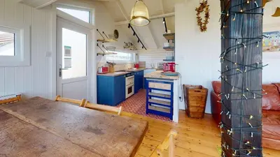 a small kitchen with a table in a room at C24 Rosemary, Riviere Towans in Hayle