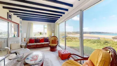 a living room with a view of the ocean at C16 Treverbyn, Riviere Towans in Hayle