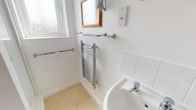 a white bathroom with a tub and a sink at C27 Eddleston, Riviere Towans in Hayle