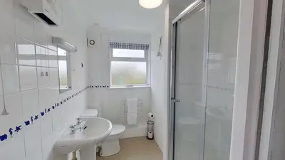a bathroom with a sink and a toilet and a shower at C41 Windmills, Riviere Towans in Hayle
