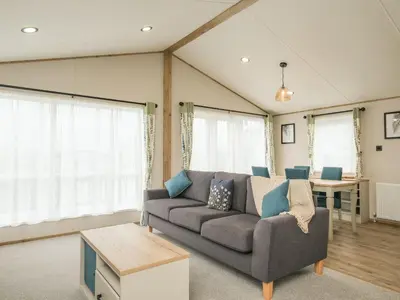 a living room with a couch and a table at Penmarlam Lodge Retreat 12 in Fowey