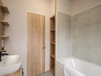 a bathroom with a white tub and a sink at Penmarlam Lodge Retreat 12 in Fowey