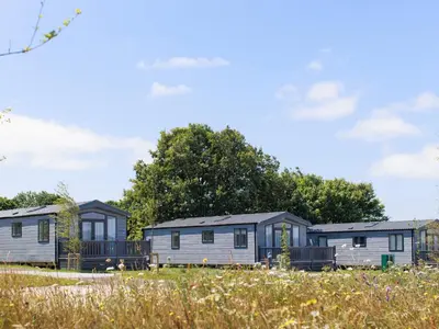 a row of mobile homes parked in a field at Penmarlam Lodge Retreat 12 in Fowey