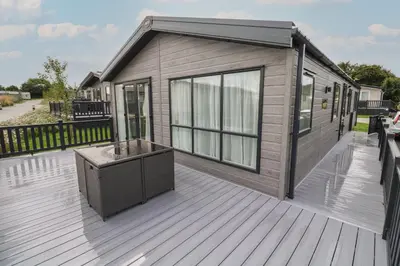 a tiny house on a deck with a solarium at Penmarlam Lodge Retreat 12 in Fowey