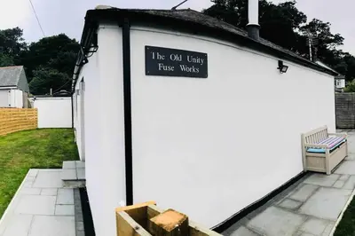 a white garage door with a sign on it at UNIQUE CORNISH COTTAGE CONVERSION Central location in Redruth