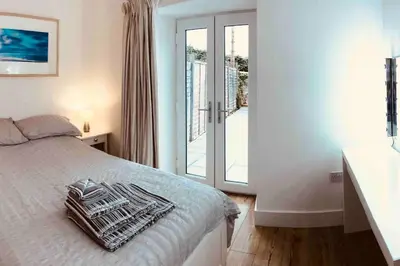 a bedroom with a bed with towels on it at UNIQUE CORNISH COTTAGE CONVERSION Central location in Redruth