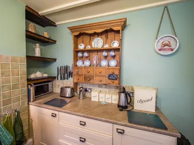 a kitchen with a sink and a counter top at Birds Nest Cottage Looe in Looe