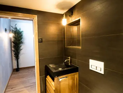 a bathroom with a sink and a mirror at Chy Glynn. Luxury lodge with hot tub and views. in St. Agnes