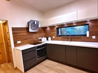 a kitchen with a sink and a counter top at Chy Mena. South facing lodge with hot tub & views. in St. Agnes