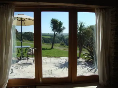 a sliding glass door with a view of a patio at BADGERS HOLLOW in Fowey