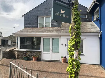 a house with a sign for a garden house at Falcon House in Tintagel