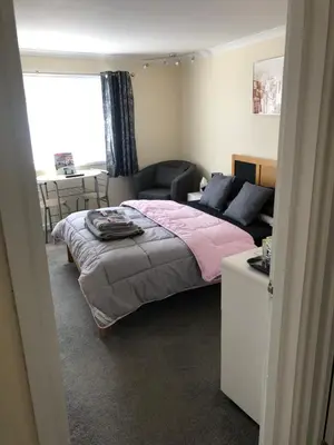 a bedroom with a bed and a couch and a table at All March 70 pounds per night with 3 nights minimum stay in St Austell