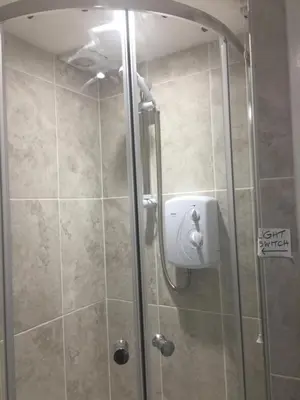 a shower in a bathroom with a glass door at All March 70 pounds per night with 3 nights minimum stay in St Austell