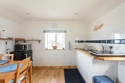 a kitchen with a sink and a counter top at Cornwall - Unique two storey barn in St Austell