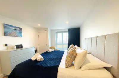 a bedroom with a large bed with pillows at 7 Ocean Gate in Newquay