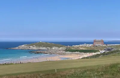 a group of people on a beach with the ocean at 7 Ocean Gate in Newquay