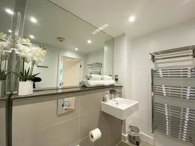 a bathroom with a sink and a mirror at 7 Ocean Gate in Newquay